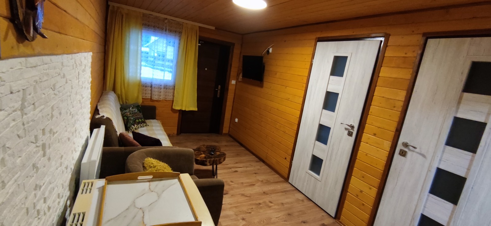 Salon z wygodną kanapą i telewizorem